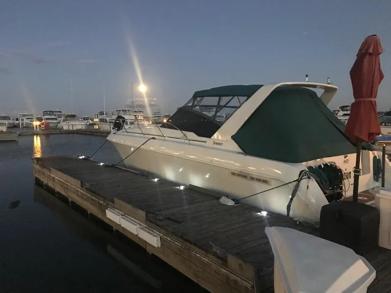 Slide: The Image of 1994 Silverton 34 Express docked at marina during evening. - 28