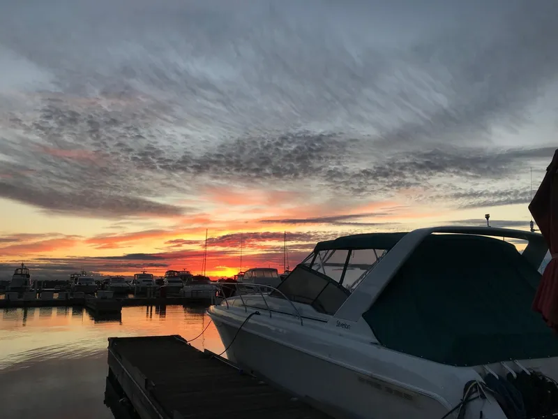 Slide: The Image of 1994 Silverton 34 Express boat docked at sunset with vibrant sky. - 29