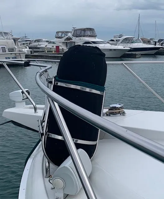 Slide: The Image of 1994 Silverton 34 Express yacht docked at marina with other boats in background. - 4