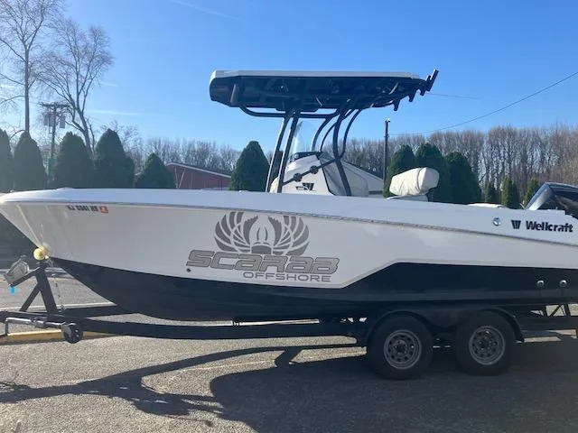 Slide: The Image of 2021 Wellcraft 222 Fisherman boat on trailer, featuring Scarab Offshore branding. - 1