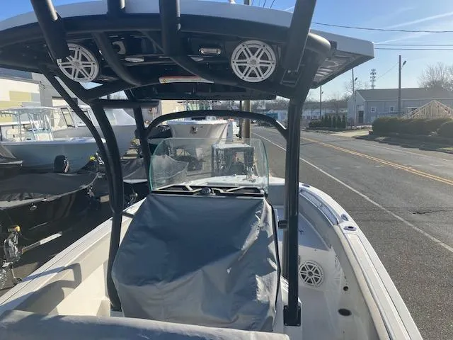 Slide: The Image of 2021 Wellcraft 222 Fisherman boat with T-top and covered console on a sunny street. - 10
