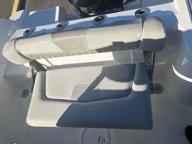 Slide: The Image of 2021 Wellcraft 222 Fisherman boat seating area with rod holders and cushioned seats. - 11