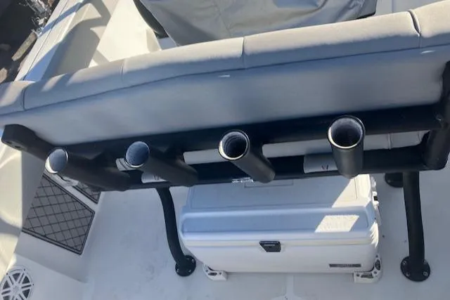 Slide: The Image of 2021 Wellcraft 222 Fisherman boat with rod holders and cooler on deck. - 14