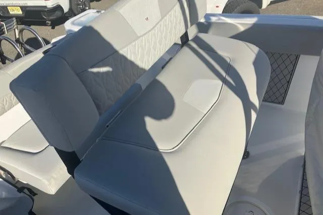 Slide: The Image of 2021 Wellcraft 222 Fisherman boat interior with gray seating and storage compartments. - 15