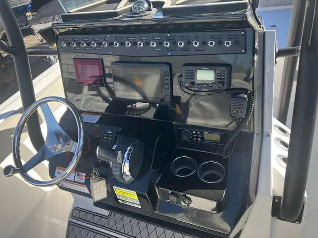 Slide: The Image of Center console of a 2021 Wellcraft 222 Fisherman boat with navigation and control systems. - 16