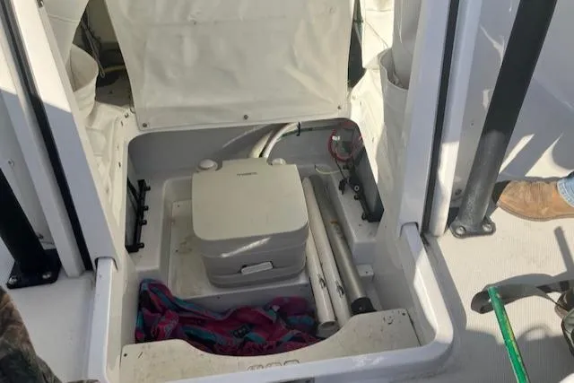 Slide: The Image of 2021 Wellcraft 222 Fisherman boat storage compartment with equipment and accessories. - 17