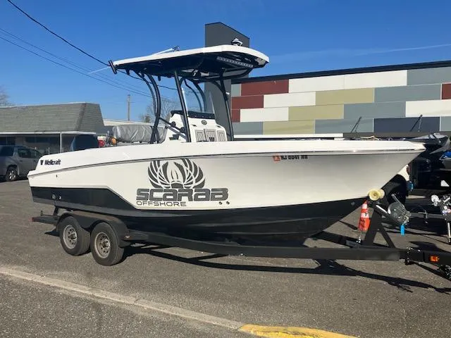 Slide: The Image of 2021 Wellcraft 222 Fisherman boat on trailer, Scarab Offshore branding, parked outdoors. - 4