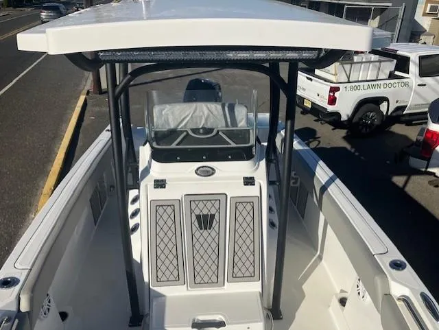 Slide: The Image of 2021 Wellcraft 222 Fisherman boat with T-top and center console, parked on a street. - 6