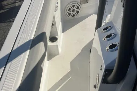 Slide: The Image of 2021 Wellcraft 222 Fisherman boat interior with rod holders and speaker. - 7