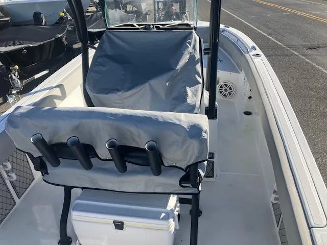 Slide: The Image of 2021 Wellcraft 222 Fisherman boat interior with covered console and rod holders. - 9