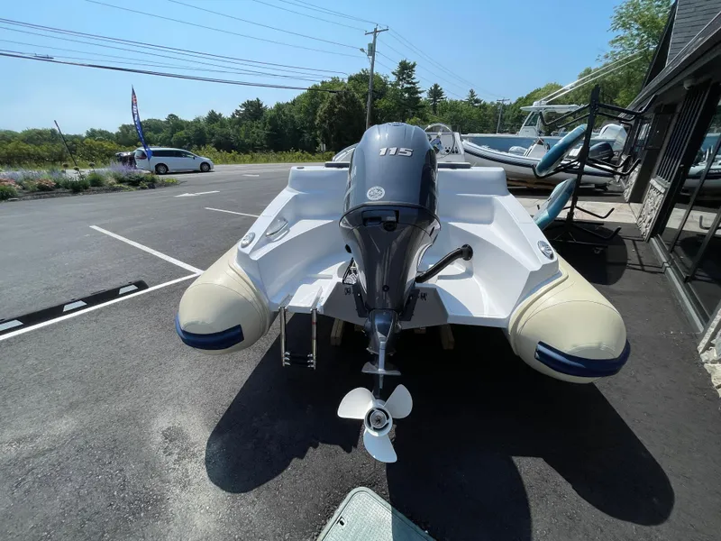 Slide: The Image of 2025 AB Inflatables Nautilus 17 DLX boat with 115 HP outboard motor, parked outdoors. - 15