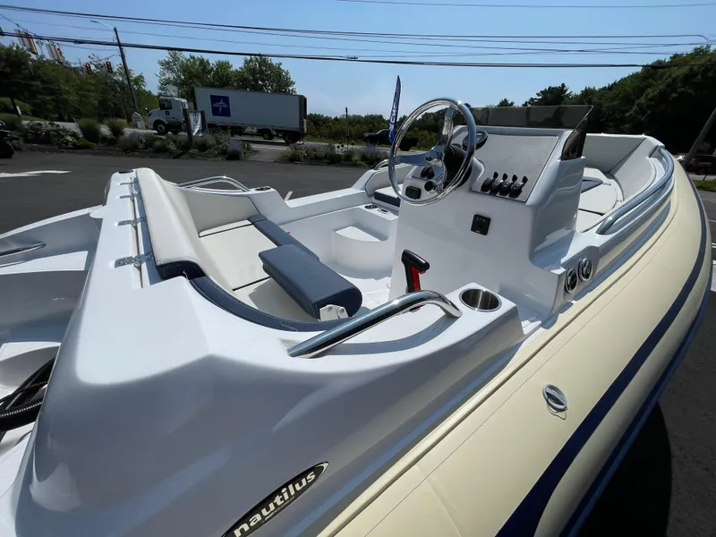 Slide: The Image of 2025 AB Inflatables Nautilus 17 DLX boat interior with steering wheel and seating. - 18