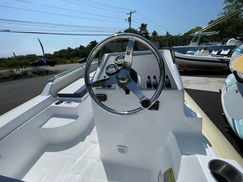 Slide: The Image of 2025 AB Inflatables Nautilus 17 DLX boat interior with steering wheel and controls. - 19