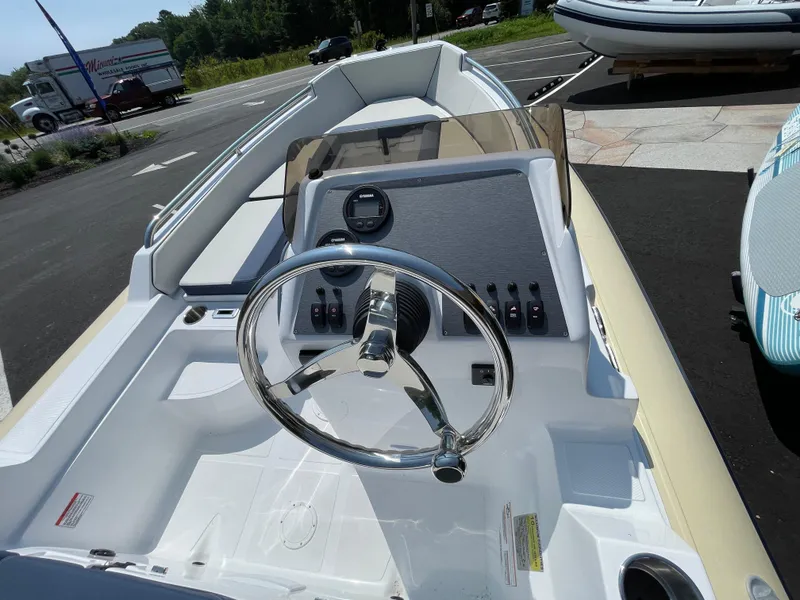 Slide: The Image of 2025 AB Inflatables Nautilus 17 DLX boat dashboard with steering wheel and controls. - 23