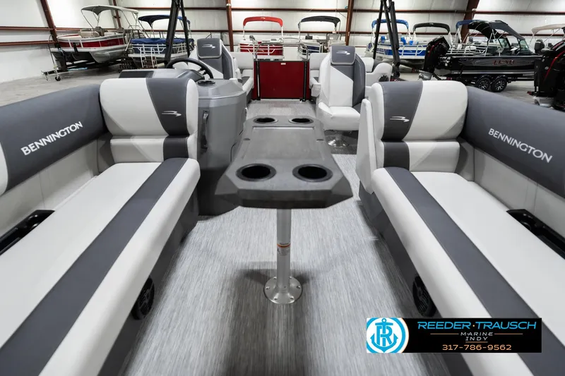 Slide: The Image of 2025 Bennington 22 SSR pontoon boat interior with gray seating and central table. - 16