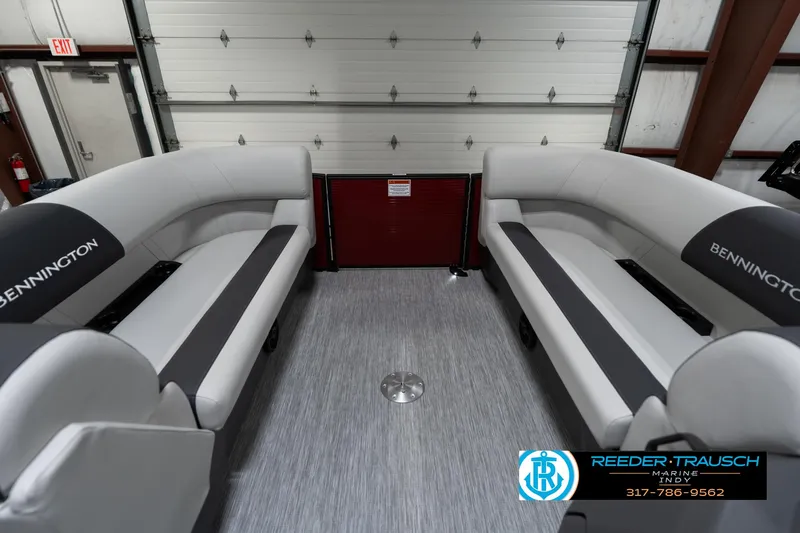 Slide: The Image of 2025 Bennington 22 SSR pontoon boat interior with gray seating in a garage. - 22
