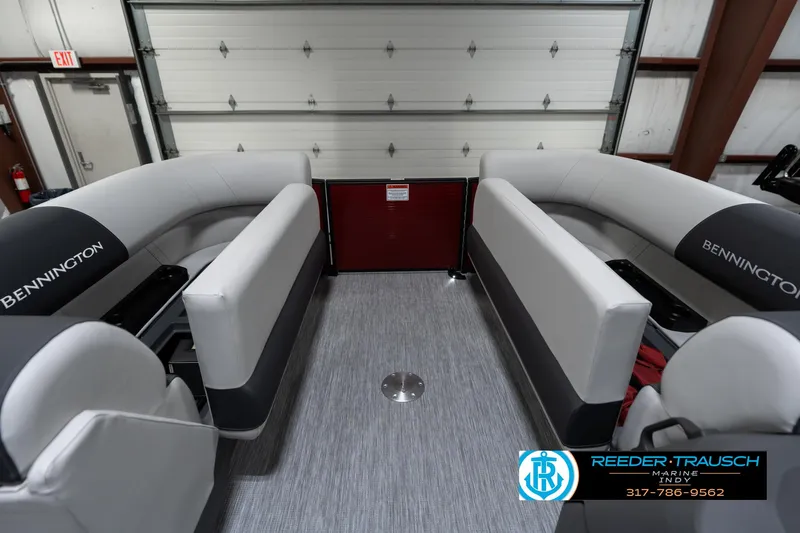 Slide: The Image of 2025 Bennington 22 SSR pontoon boat interior with gray seating in a garage. - 23