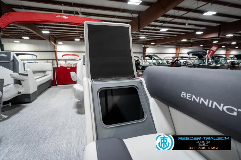 Slide: The Image of 2025 Bennington 22 SSR boat interior with open storage compartment in showroom. - 25