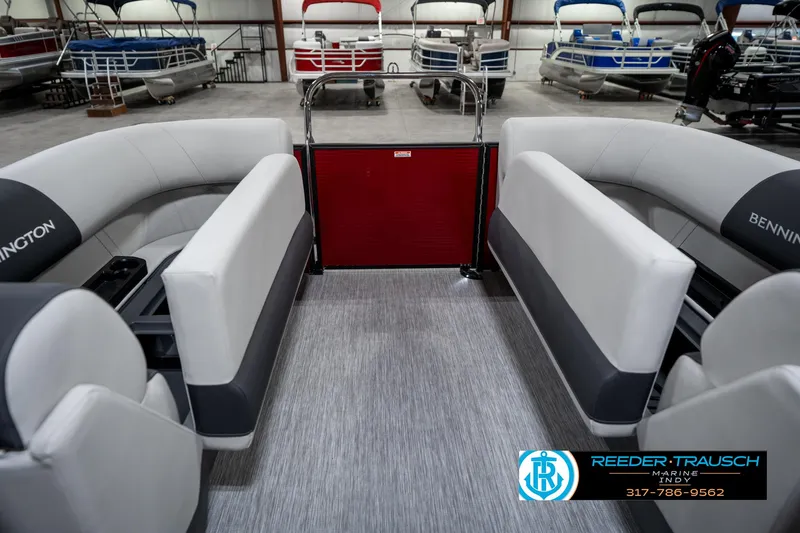 Slide: The Image of 2025 Bennington 22 SSR pontoon boat interior with gray seating in a showroom. - 27