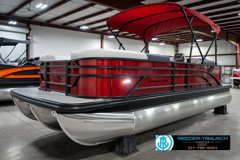 Slide: The Image of 2025 Bennington 22 SSR pontoon boat with red canopy in showroom. - 3
