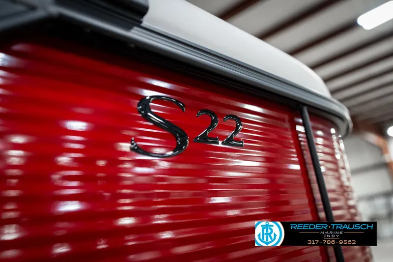 Slide: The Image of 2025 Bennington 22 SSR boat with red exterior and "S22" emblem. - 47