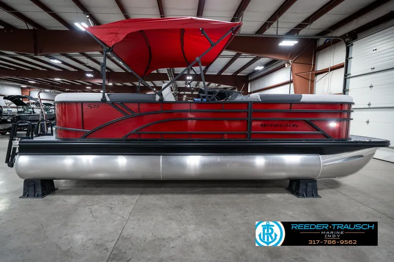Slide: The Image of 2025 Bennington 22 SSR pontoon boat with red canopy in showroom. - 7