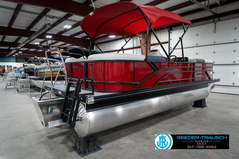 Slide: The Image of 2025 Bennington 22 SSR pontoon boat with red canopy in showroom. - 8