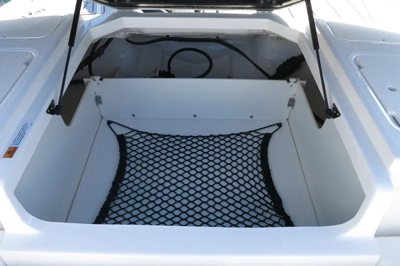 Slide: The Image of Open storage compartment in 2025 Chaparral 21 SSi Outboard boat with netting. - 19