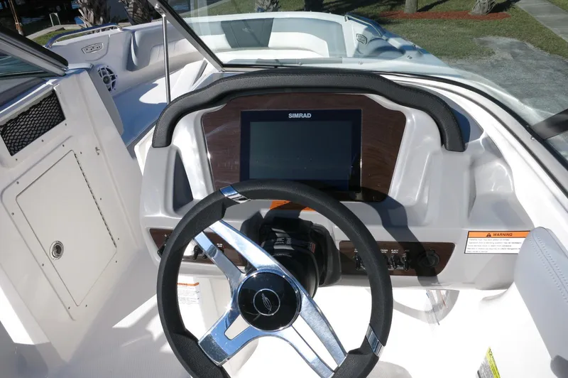 Slide: The Image of 2025 Chaparral 21 SSi Outboard dashboard with steering wheel and digital display. - 25