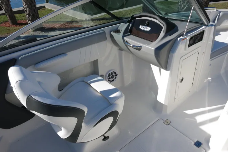 Slide: The Image of 2025 Chaparral 21 SSi Outboard boat interior with sleek helm and comfortable seating. - 26
