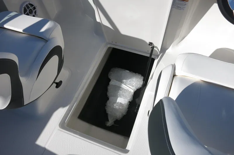 Slide: The Image of 2025 Chaparral 21 SSi Outboard boat interior with storage compartment and seating. - 28