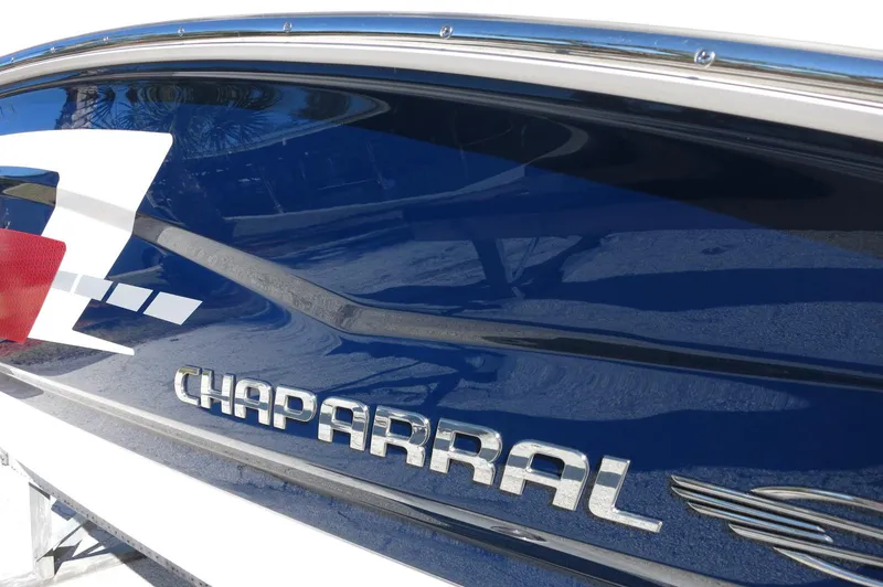 Slide: The Image of 2025 Chaparral 21 SSi Outboard boat with sleek blue and white design. - 3