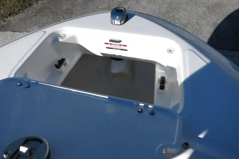 Slide: The Image of 2025 Chaparral 21 SSi Outboard boat storage compartment, open and empty. - 35