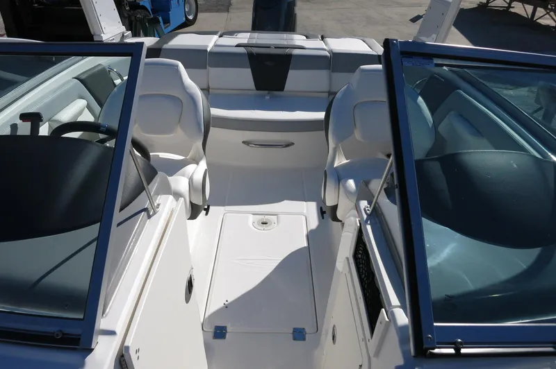 Slide: The Image of 2025 Chaparral 21 SSi Outboard boat interior with seating and open windshield. - 36