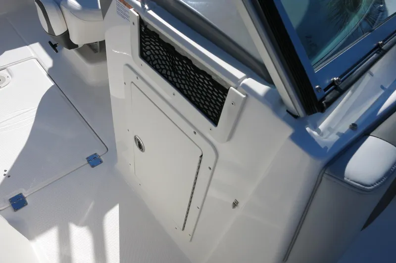 Slide: The Image of 2025 Chaparral 21 SSi Outboard boat interior, featuring storage compartment and seating area. - 37