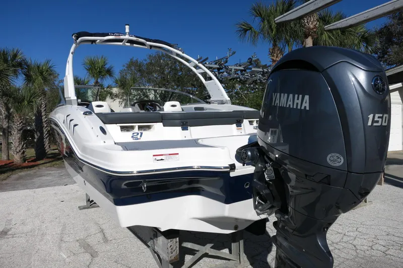 Slide: The Image of 2025 Chaparral 21 SSi Outboard boat with Yamaha 150 engine, parked outdoors. - 5