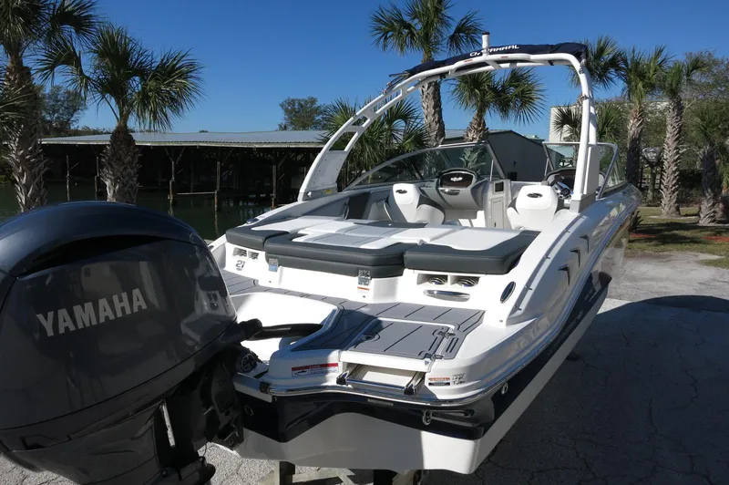 Slide: The Image of 2025 Chaparral 21 SSi Outboard boat with Yamaha engine, parked near palm trees. - 9