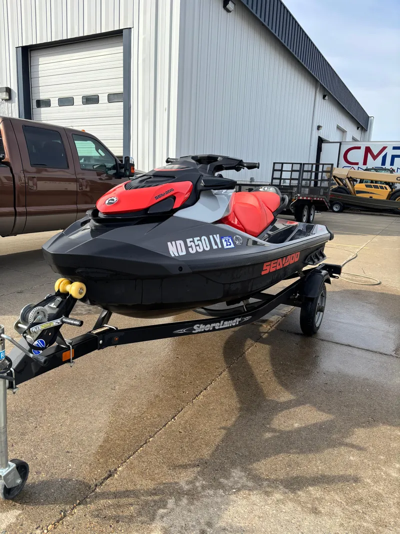 Slide: The Image of 2023 Sea-Doo GTI SE 170 jet ski on trailer, parked outdoors. - 2