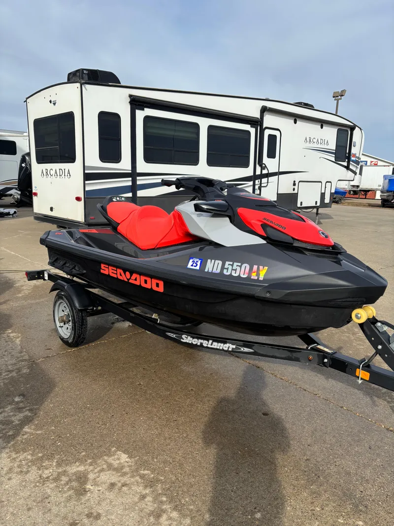 Slide: The Image of 2023 Sea-Doo GTI SE 170 jet ski on trailer, parked near a camper. - 5