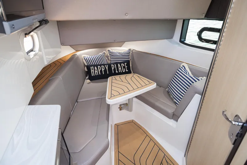 Slide: The Image of 2026 Hurricane SunDeck 3200 OB boat seating area with cup holders and speakers. - 10