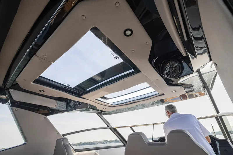 Slide: The Image of 2026 Hurricane SunDeck 3200 OB boat seating with cup holders and speakers. - 12