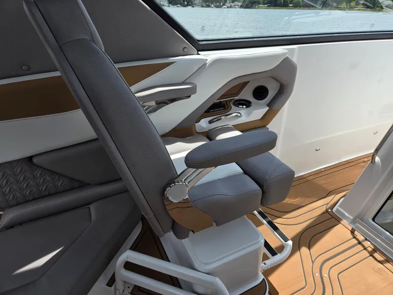 Slide: The Image of Hurricane SunDeck 3200 OB 2026 boat storage compartment with open lid on deck. - 19