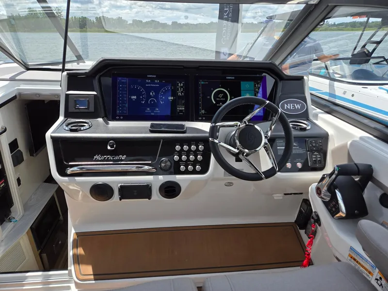 Slide: The Image of 2026 Hurricane SunDeck 3200 OB helm with dual Simrad displays and modern steering wheel. - 20