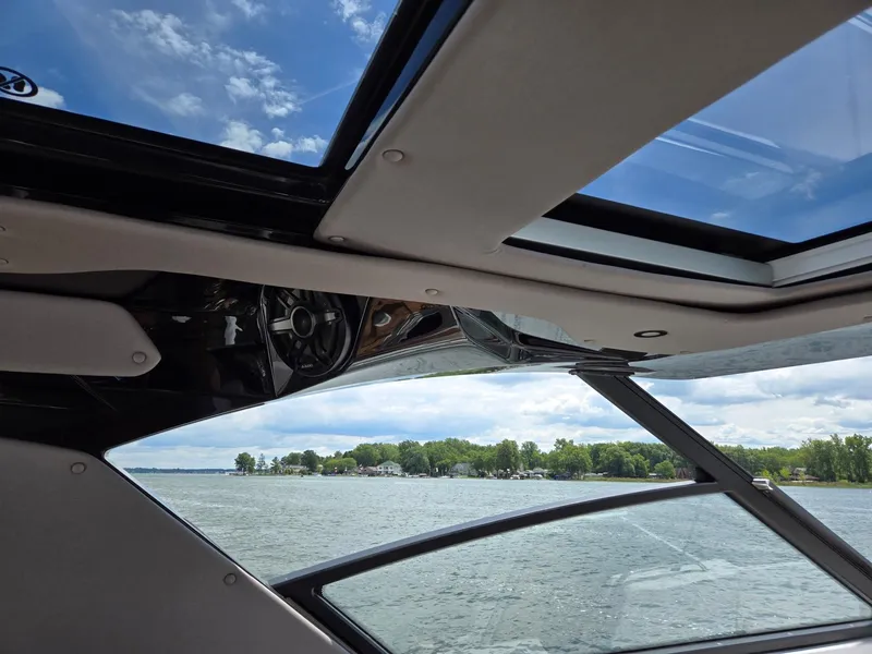 Slide: The Image of Control panel of 2026 Hurricane SunDeck 3200 OB boat with safety warnings and buttons. - 23