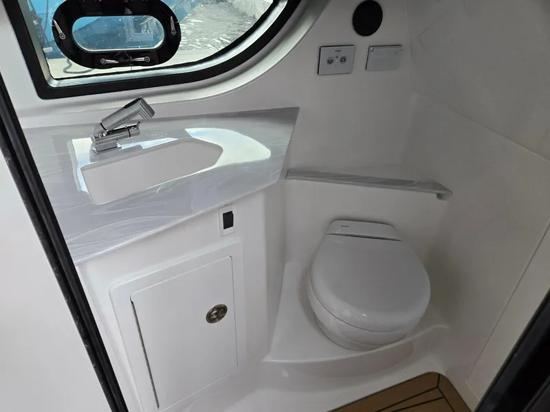 Slide: The Image of 2026 Hurricane SunDeck 3200 OB boat interior with dual captain's seats and control panel. - 33