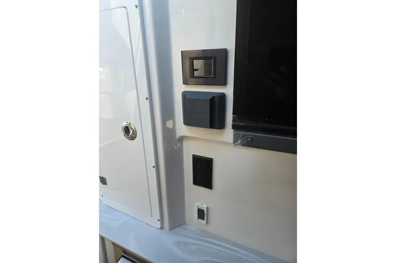 Slide: The Image of Control panel and speaker on 2026 Hurricane SunDeck 3200 OB boat interior. - 54