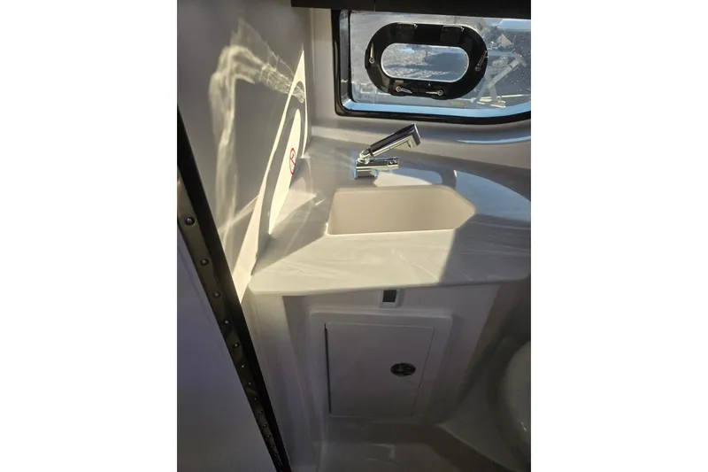 Slide: The Image of 2026 Hurricane SunDeck 3200 OB boat interior with sink and window. - 57