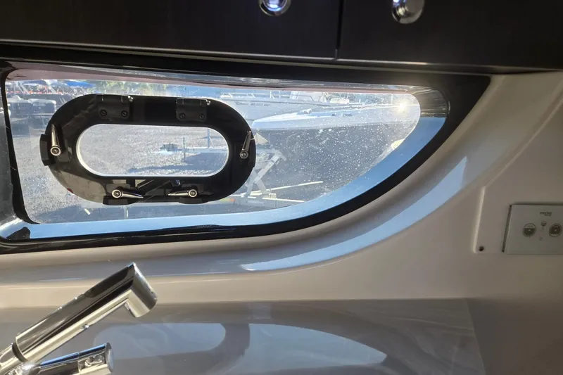 Slide: The Image of Interior view of 2026 Hurricane SunDeck 3200 OB boat window and faucet. - 58