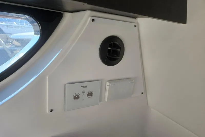 Slide: The Image of Interior view of 2026 Hurricane SunDeck 3200 OB boat, featuring control panel and vent. - 59