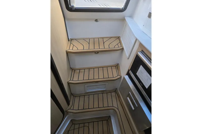 Slide: The Image of Interior stairs of 2026 Hurricane SunDeck 3200 OB with wood finish and modern design. - 63
